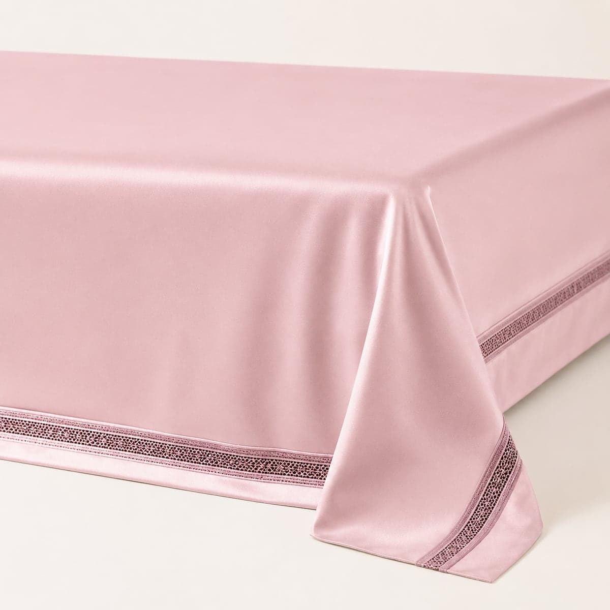 The Blush Pink sheet draped over the edge of the bed