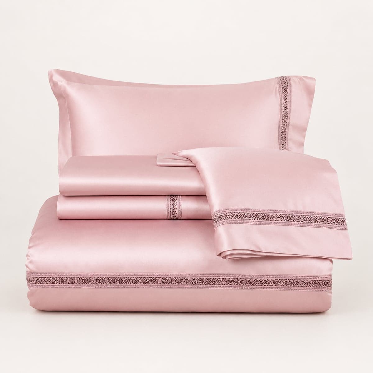 The Blush Pink set folded: duvet cover, sheet and pillowcases