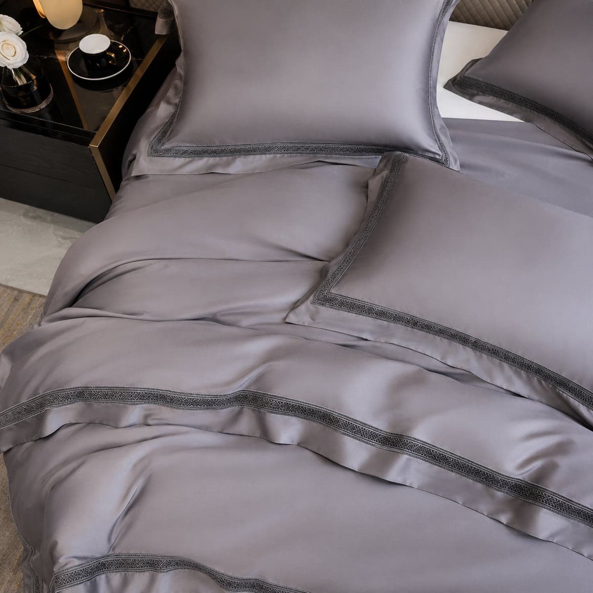 Close-up of the Dove Grey bedding on a made bed